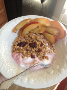 Strawberry Greek yogurt, granola, and a plum from the farmer's market